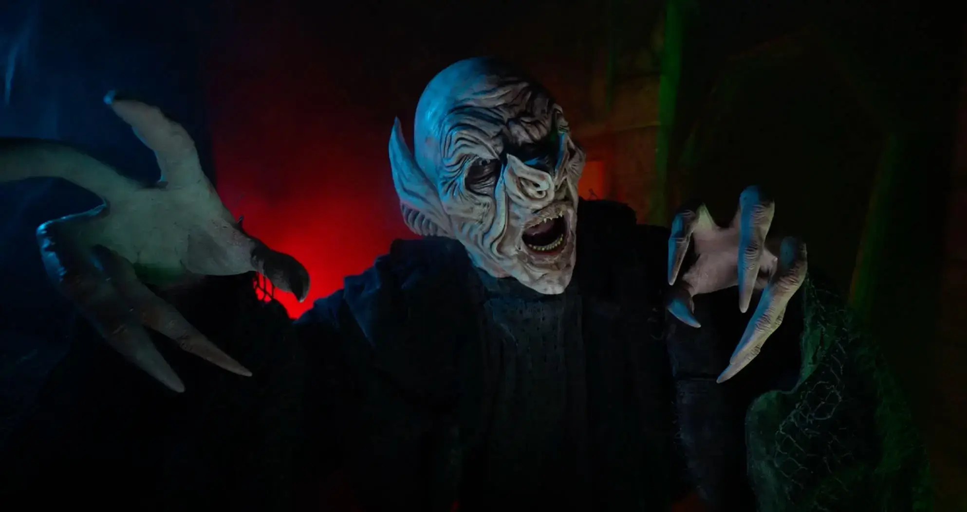 Screaming haunted house actor with monster mask