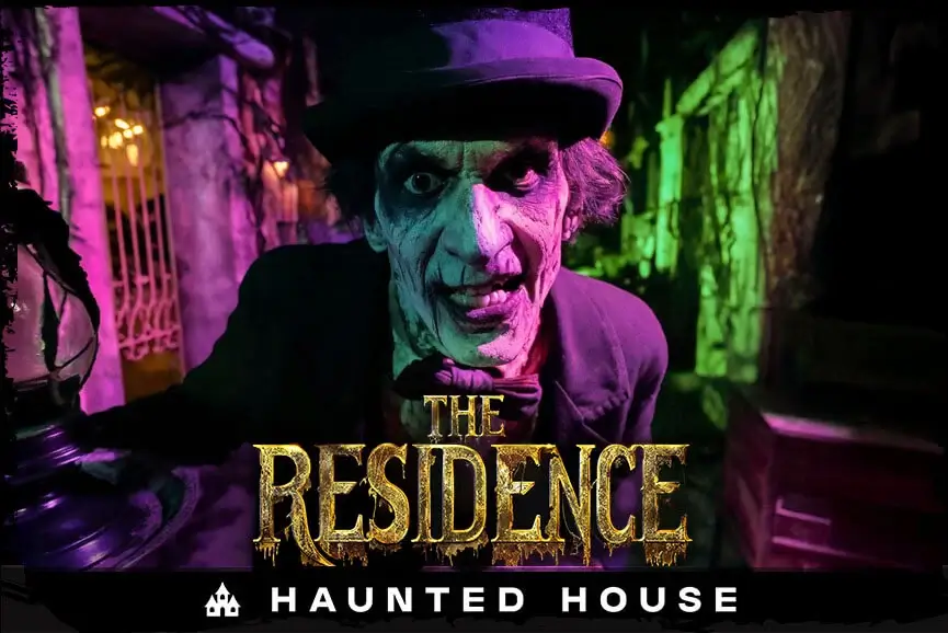 Creep actor with top hat at haunted attraction