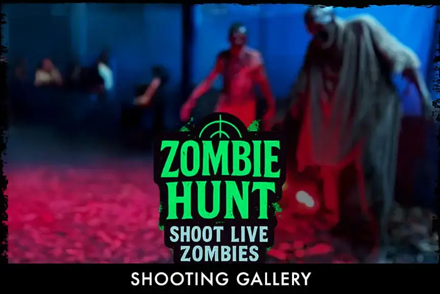 player aims GellyBall blaster at zombies in “Shoot to Survive” shooting gallery at Haunted Web Scream Park, Memphis TN
